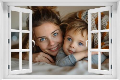 Closeup boy lying on bed with mother hugging