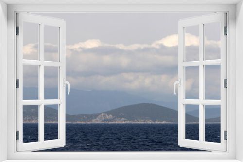 View from the deck of a steamship on a small island in the Aegean Sea.