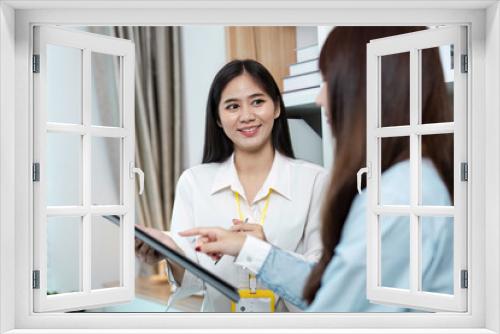 Professional Business Meeting with Two Women Discussing Document in a Modern Office Environment