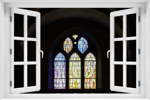 Sun light through the leaded pane in old majestic church