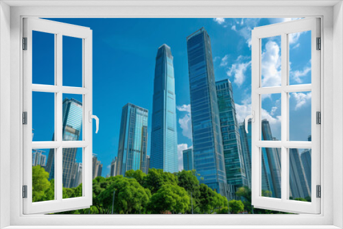 Skyscrapers Reaching into a Bright Blue Sky with White Clouds on a Sunny Day