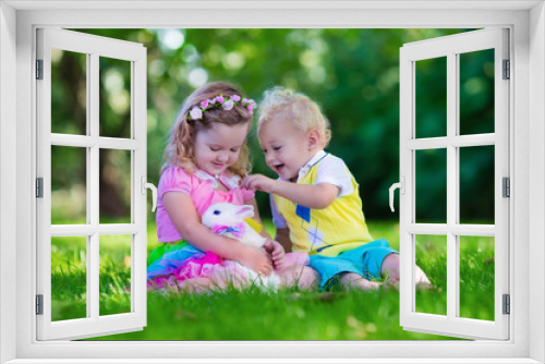 Kids playing with pet rabbit