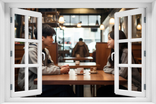 Asian young two teenagers students couple friends siting in cafe smiling having a date. First love and friendship concept.