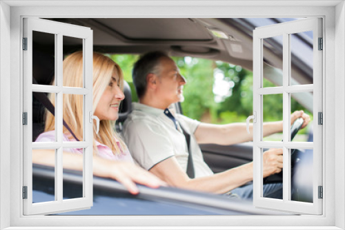 Mature couple traveling in their car