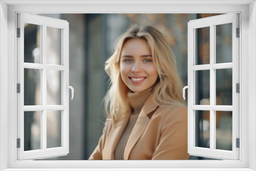 beautiful smiling blonde businesswoman near a business house and looking at the camera