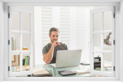 architect sitting at office working on his laptop