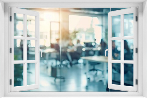 Blurred office space through glass doors. A view of a contemporary office space through glass doors with people working inside, creating a blurred effect.