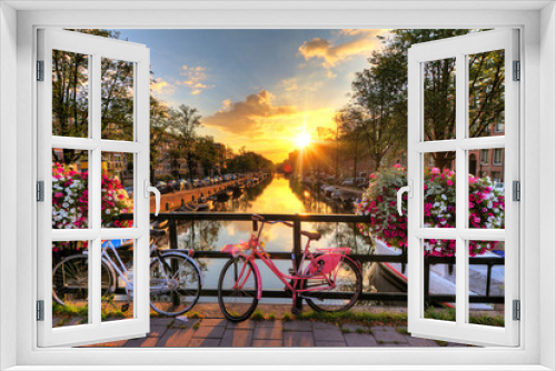 Fototapeta Naklejka Na Ścianę Okno 3D - Beautiful sunrise over Amsterdam, The Netherlands, with flowers and bicycles on the bridge in spring