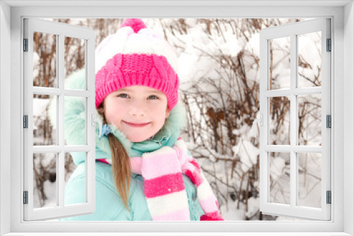 Portrait of smiling little girl in winter day