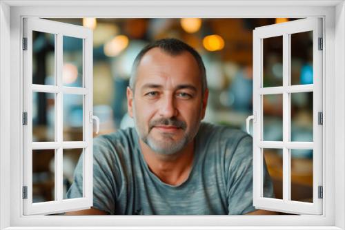 A man sitting at a table in a restaurant.