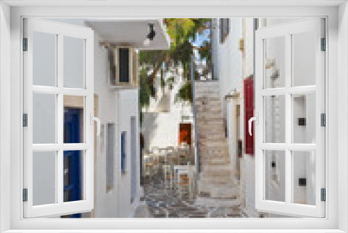 Fototapeta Naklejka Na Ścianę Okno 3D - Street with traditional architecture and decorated cobble stone pavement in Naousa village on Paros island, Greece