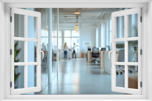 Modern office hallway with glass walls and a plant.