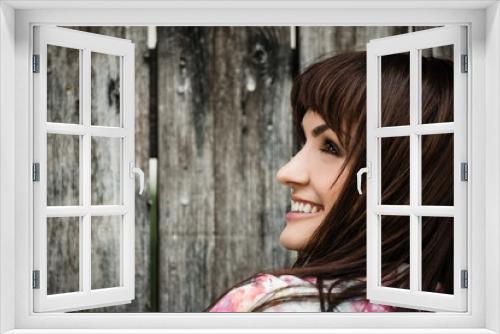 Woman portrait on wooden fence background