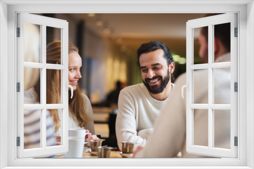 happy friends meeting and drinking tea or coffee