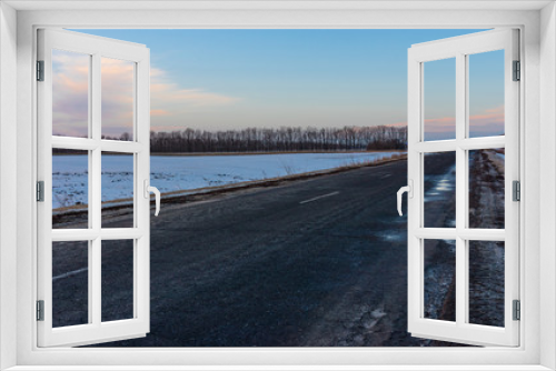 Fototapeta Naklejka Na Ścianę Okno 3D - Winter landscape with an empty country road in Ukraine at evening time