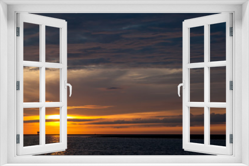 Offshore oil and gas platform at sunset on the North Sea north of the Netherlands