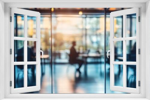 Blurred silhouettes of business people in a modern office setting with sunlight filtering through large windows. AI generated image