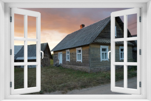 Fototapeta Naklejka Na Ścianę Okno 3D - old wooden house in the village against sunset