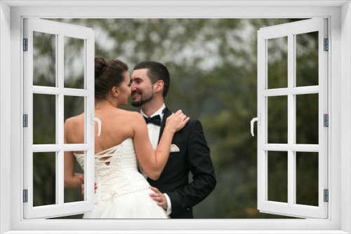 bride and groom dance together in the woods