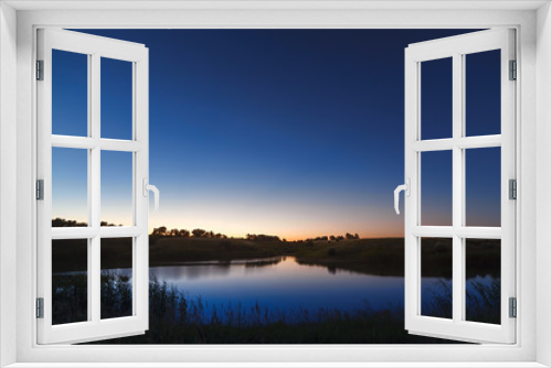 Fototapeta Naklejka Na Ścianę Okno 3D - Morning dawn on a starry background sky reflected in the water o
