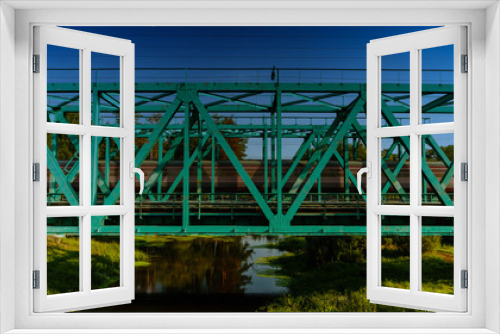Fototapeta Naklejka Na Ścianę Okno 3D - Train passing on the railway bridge