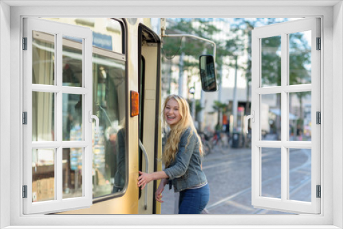 young blond student is going into a tram