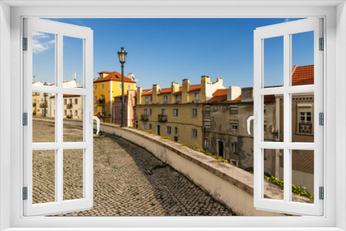 Fototapeta Naklejka Na Ścianę Okno 3D - Street in Alfama, Lisbon, with old cobblestone and tiles