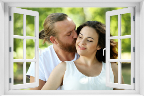 Portrait of embracing couple in the park, close up