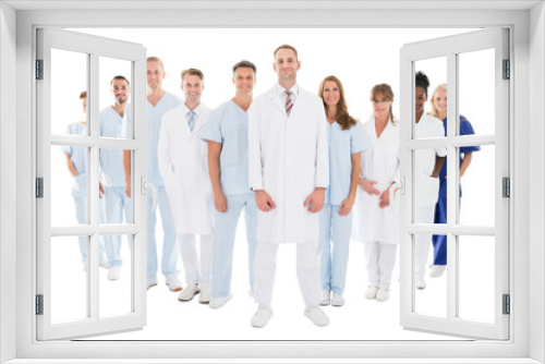 Portrait Of Confident Doctor Standing With His Team