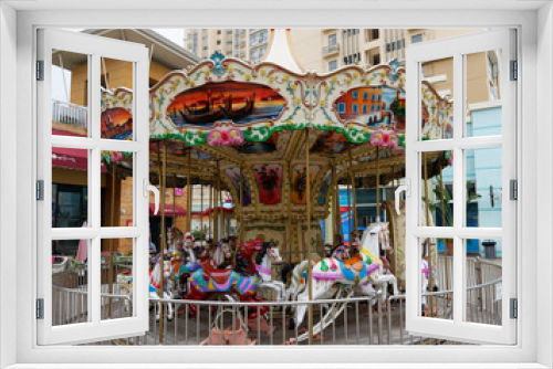 Fototapeta Naklejka Na Ścianę Okno 3D - Colourful carousel with horses on a street