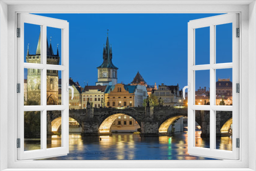 Fototapeta Naklejka Na Ścianę Okno 3D - Evening view of the Charles Bridge in Prague, Czech Republic, with Old Town Bridge Tower, Old Town Water Tower and dome of the National Theatre