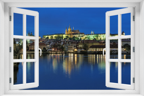 Prague, Czech Republic. Evening view of the Prague Castle with St. Vitus Cathedral, Castle district, Mala Strana district with St. Nicholas Church, and Charles Bridge with Mala Strana Bridge Towers.