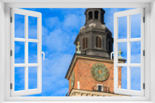 City Hall tower against blue sky on main market square of Krakow, Poland