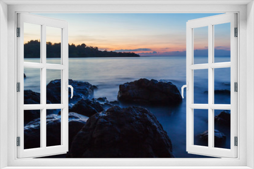 Fototapeta Naklejka Na Ścianę Okno 3D - Rock in blue sea at sunset.