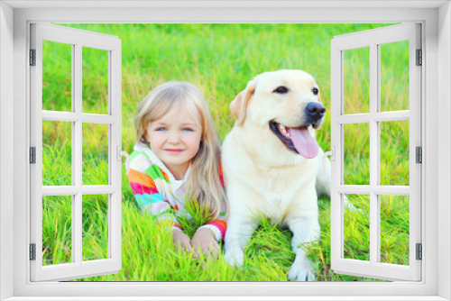 Fototapeta Naklejka Na Ścianę Okno 3D - Portrait child and labrador retriever dog lying on grass in summ