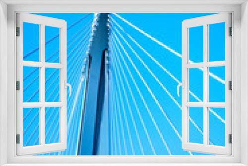 Fototapeta Naklejka Na Ścianę Okno 3D - Modern suspension bridge steel ropes against blue sky background