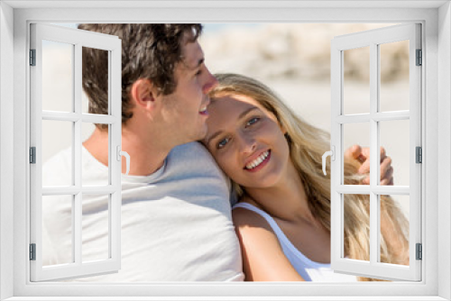 Romantic young couple sitting on the beach