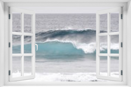 Fototapeta Naklejka Na Ścianę Okno 3D - Blue wave rolls towards a beach