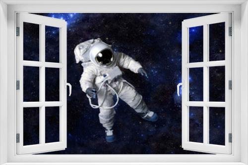 Fototapeta Naklejka Na Ścianę Okno 3D - Astronaut floating in dark space.