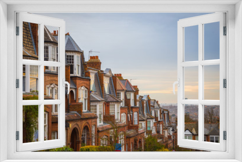 Fototapeta Naklejka Na Ścianę Okno 3D - Traditional British brick houses on a cloudy morning with east London at background. Panoramic shot from Muswell Hill, London, UK