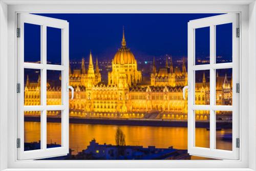 Fototapeta Naklejka Na Ścianę Okno 3D - Budapest Parliament building illuminated at dusk reflected in Danube river in Hungary