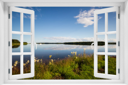 Fototapeta Naklejka Na Ścianę Okno 3D - A beautiful summer day in northern Sweden. A lake with calm water, blue skies and green grass. 