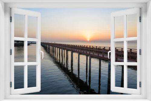Fototapeta Naklejka Na Ścianę Okno 3D - The wooden bridge in the sea with sunrise in the morning