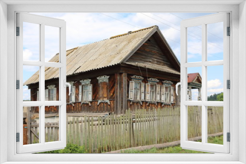 Fototapeta Naklejka Na Ścianę Okno 3D - Very old wooden house in the remote Russian village in the summer